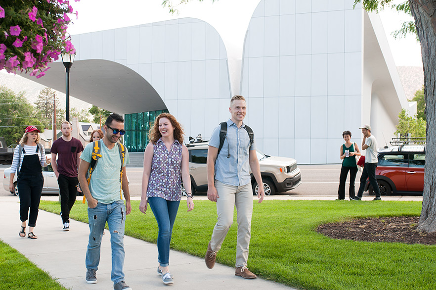 Students walking in front of the SUMA building 23