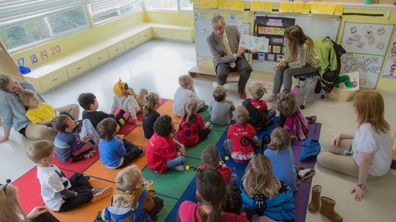 President Scott and Kathy Wyatt reading to elementary kids