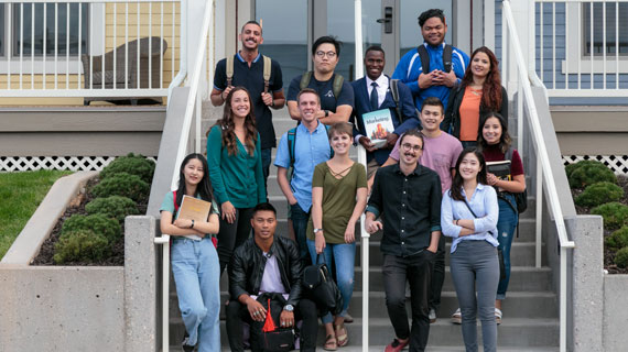 SUU International students posed in front of housing