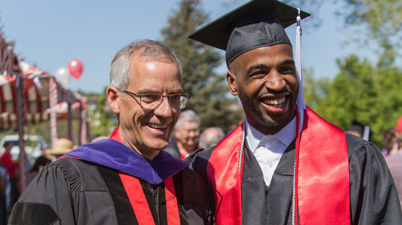President Scott Wyatt and graduating student at commencement