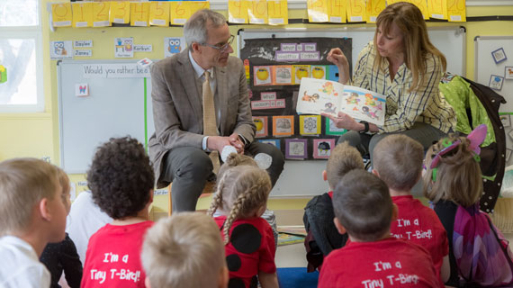 president scott and kathy wyatt reading books to daycare children