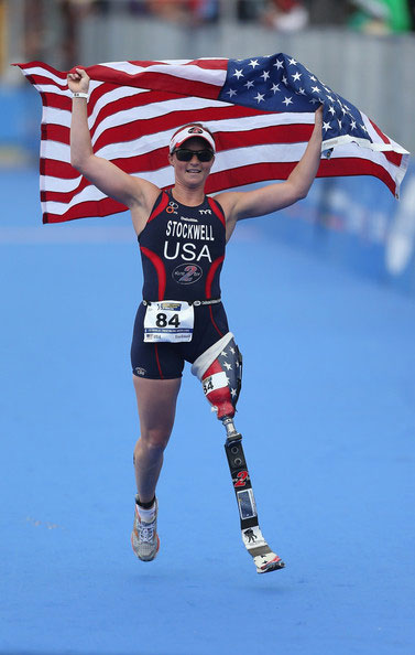 Melissa Stockwell picture running with flag, honorary doctorate recipient 