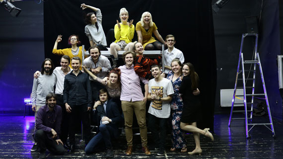 SUU students on the stage in Romania before a performance of The Last Yankee